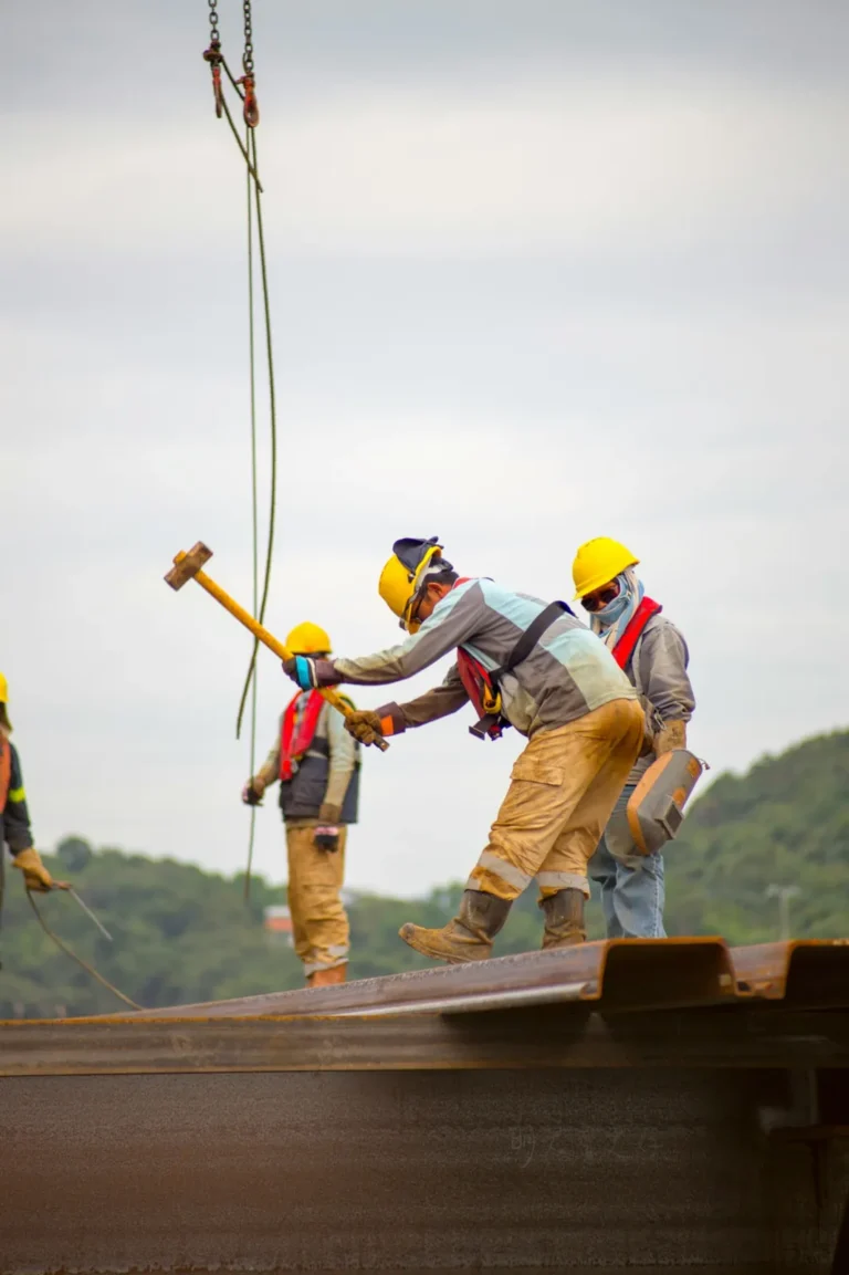 Construction workers in hard hats working together outdoors