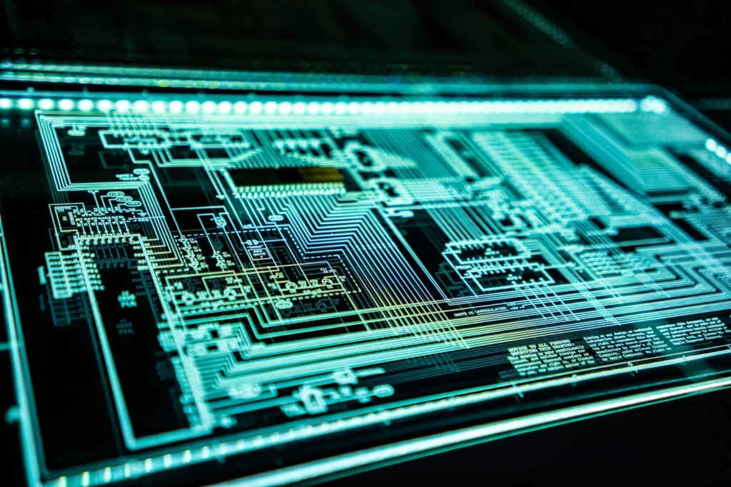 Close-up of a computer circuit board illuminated in green.