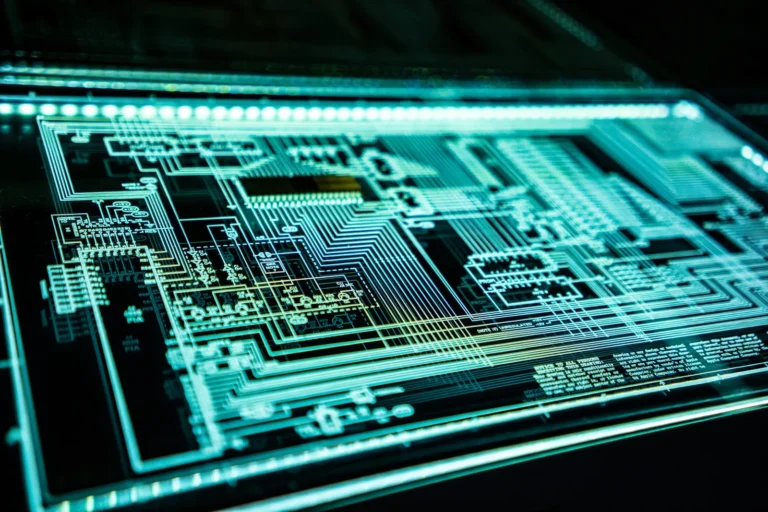 Close-up of a computer circuit board illuminated in green.