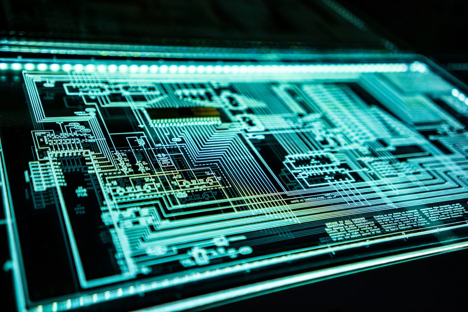 Close-up of a computer circuit board illuminated in green.