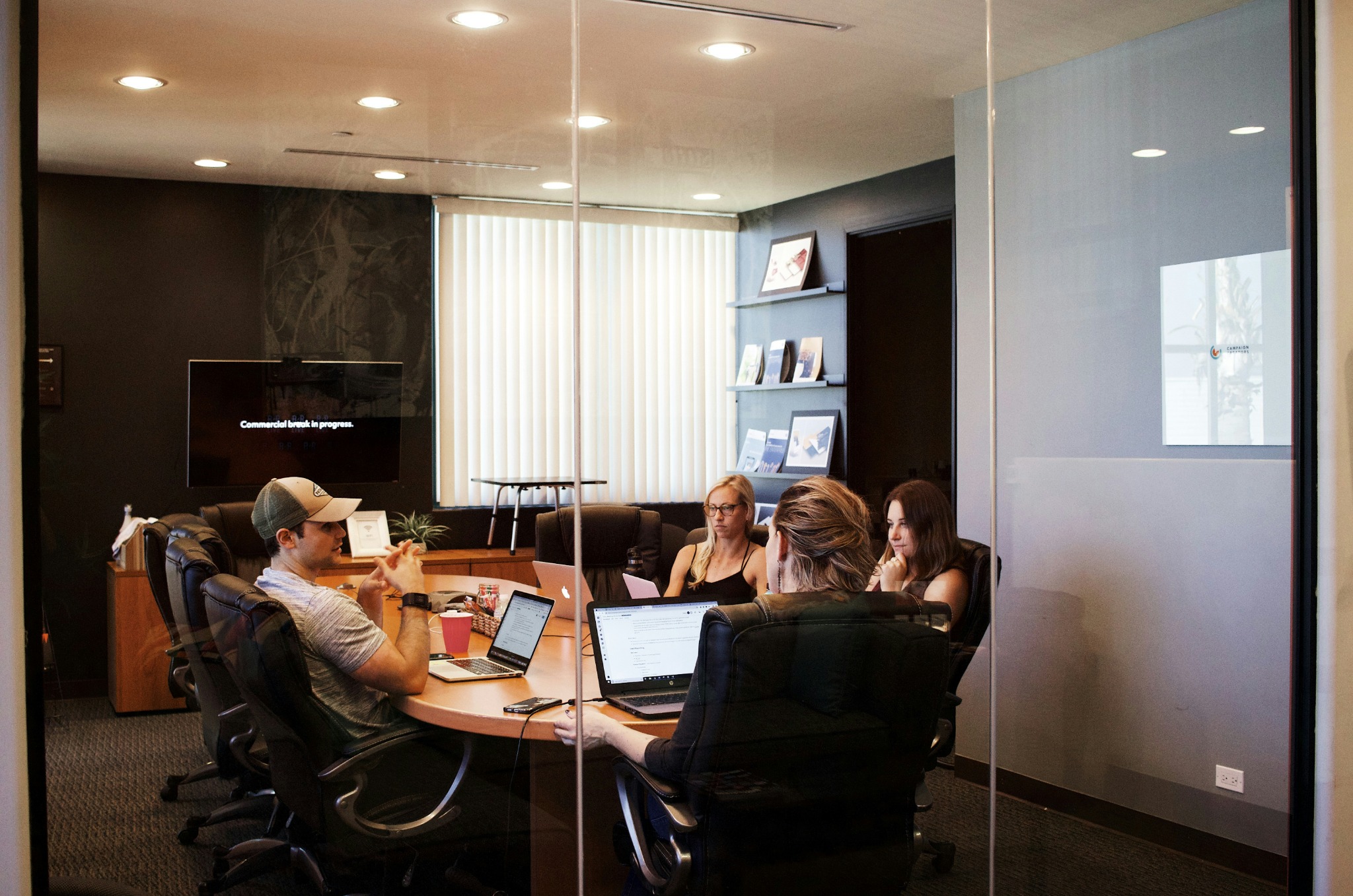 Colleagues discussing work around a conference table