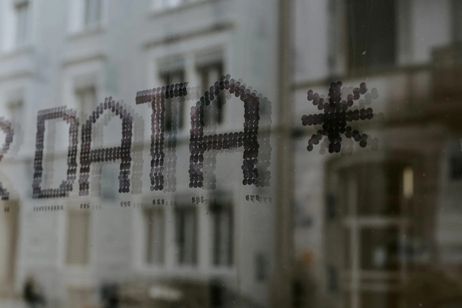 The word data displayed on a window with buildings behind it