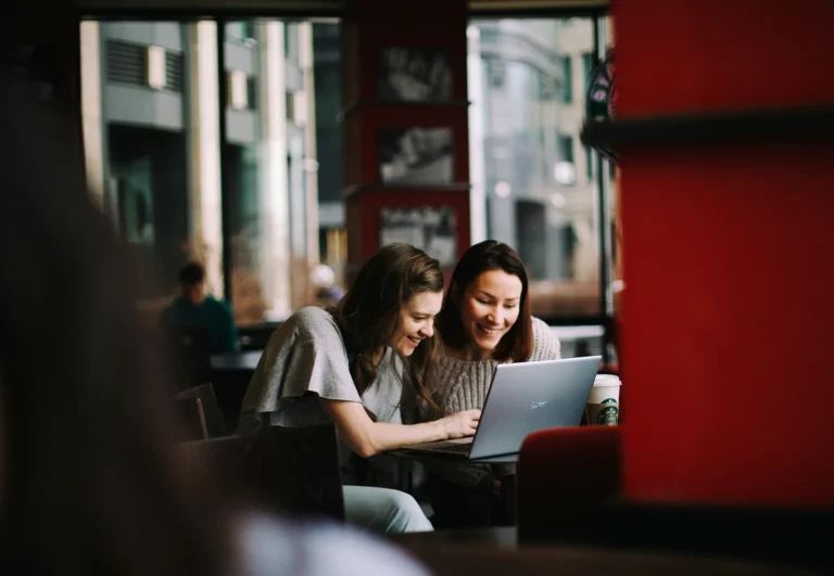 Two women looking at a laptop together