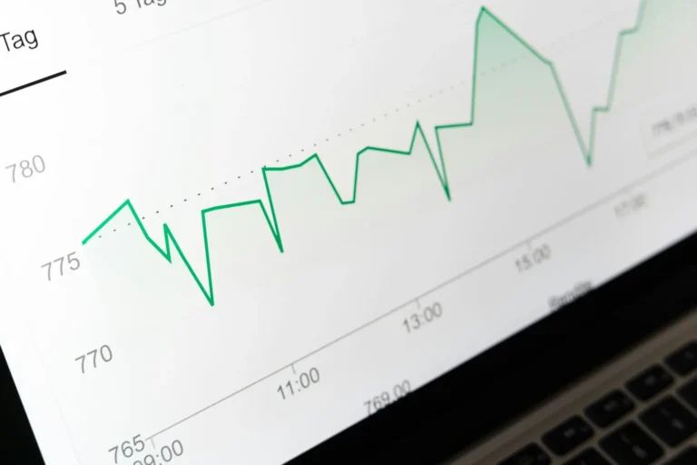 Green line chart displayed on a laptop screen