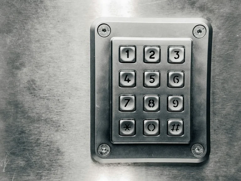 A metal access keypad with numbered buttons.